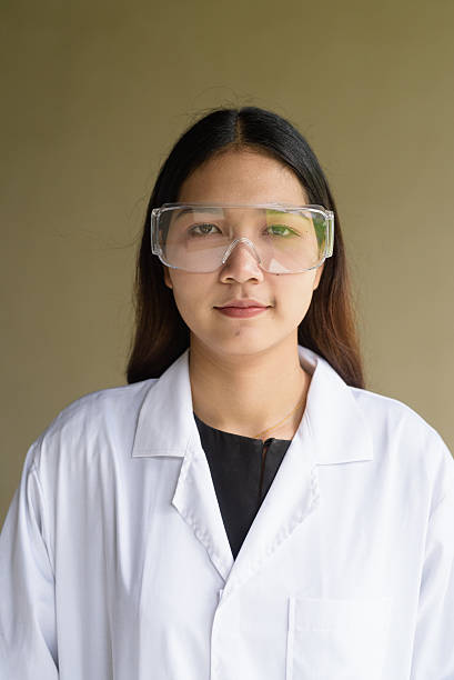istock Scientist woman wearing lab coat and goggles 2223931291