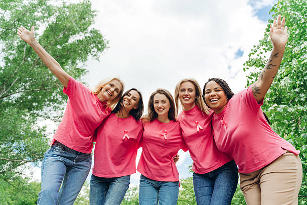 istock Smiling women embracing and supporting breast cancer awareness 2223933251