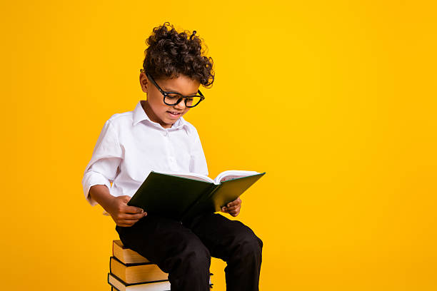 istock Portrait of intelligent diligent schoolkid sit pile stack book read prepare test empty space isolated on yellow color background 2223933917