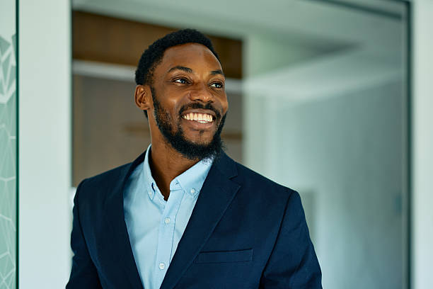 istock Smiling businessman looking away in modern office 2223934396