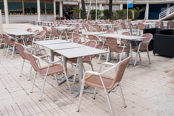 istock Empty outdoor cafe with pink chairs and tables on a patio 2223937104
