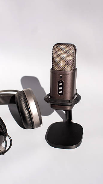 Microphone and headphones set for podcast recording on white background