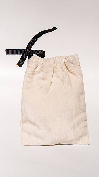 istock Cream drawstring pouch with black ribbon on white background 2223937110
