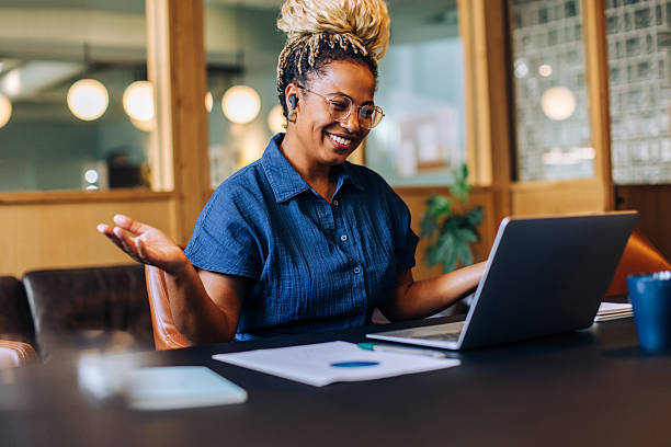 istock Happy woman at work using a laptop in an office environment 2223939416