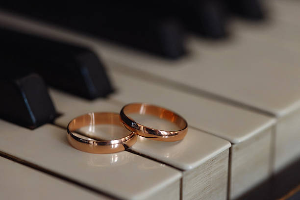 istock Two wedding rings on piano keys. 2223939595