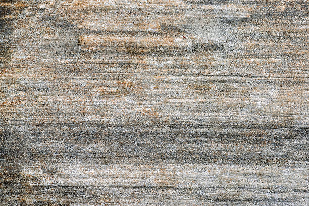 Natural stone surface displays a blend of earthy tones with textured patterns formed by time and elements, providing a rustic aesthetic.