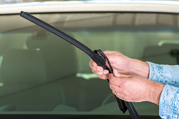 istock Car mechanic replaces a windshield wiper 2223943677