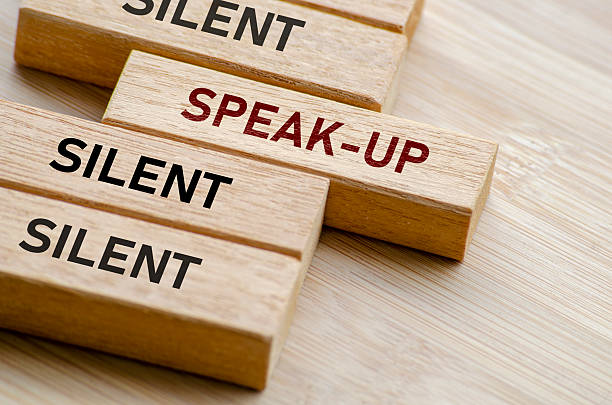 istock Silent, speak up, and silent again message on blocks, illustrating the tension between voicing out and holding back in critical moments 2223951541