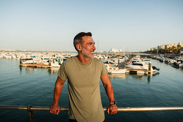 istock Smiling mature man enjoying the view at the marina 2223952575