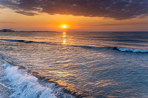 istock Meditative sunrise over tranquil beach waters 2223956538