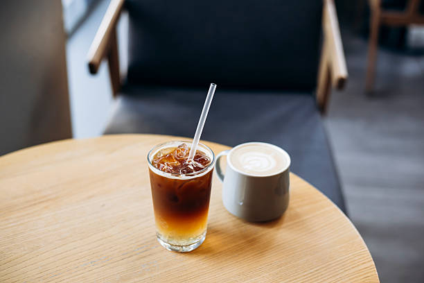 istock Espresso tonic and cappuccino on table in cozy cafe interior. 2223957154
