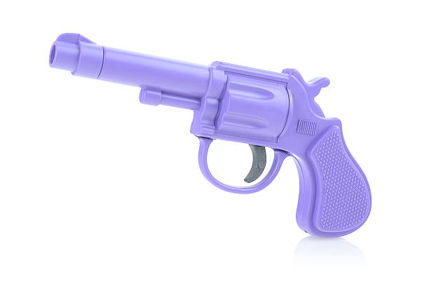 istock A purple toy revolver on a white background. 2223962369