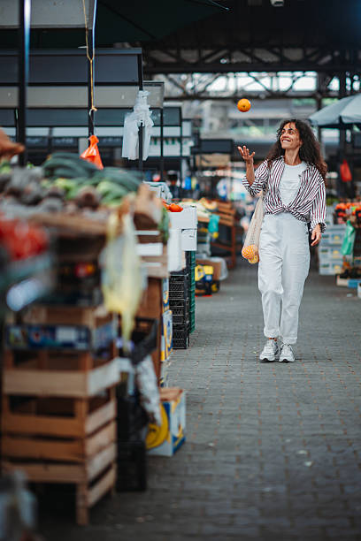 Woman enjoying fresh produce at outdoor market