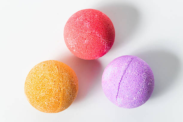 istock Colorful bath bombs arranged in a playful manner on a white background 2223963272