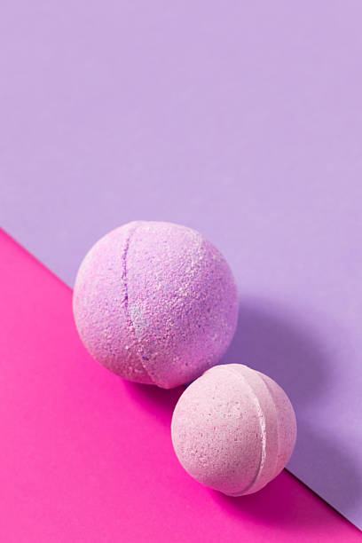 istock Colorful bath bombs on a pink and purple background create a playful aesthetic 2223963284