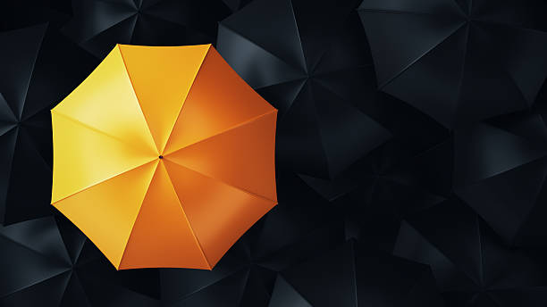 istock Yellow Umbrella Surrounded by Black Umbrellas 2223975576