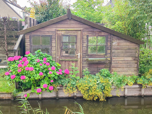 istock Wooden shed with pink flowers 2223977102