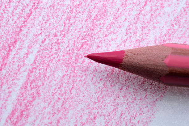 Vibrant red pencil surrounded by colorful pencil tips. Art & stationery supplies.