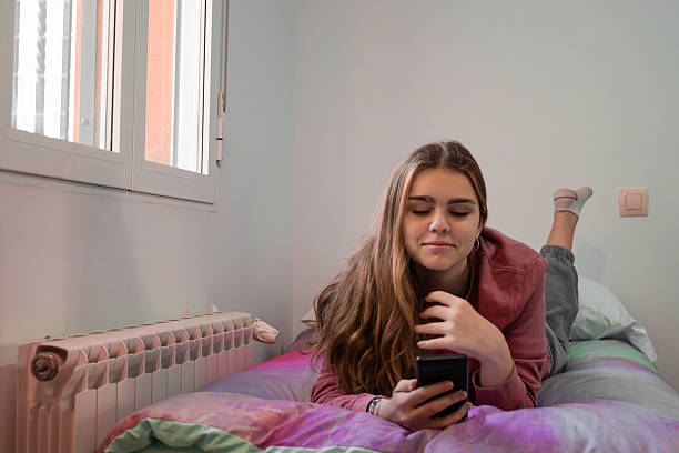 istock Average teenager smiling while looking at their phone 2223989913