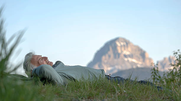 istock Senior man lies in mountain meadow, springtime 2223995132