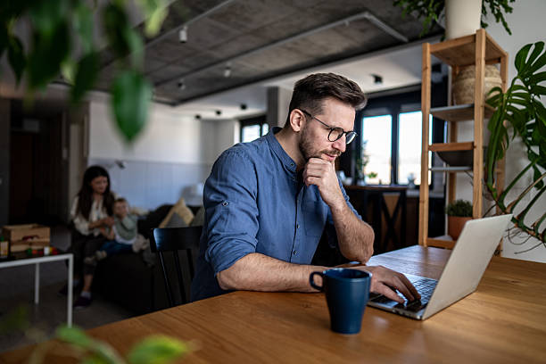 istock Focused young adult man working remotely at home 2223995818