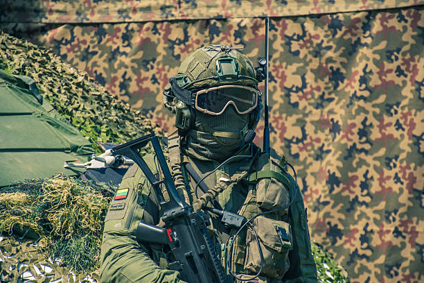 A soldier in tactical gear, under artistic lighting, with a deep and intense gaze. The scene combines atmospheric shadows and precision to evoke tension, focus, and determination reflecting a cinematic action moment.
