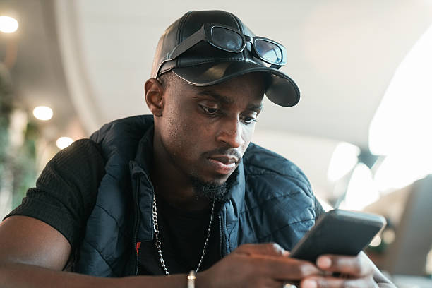 istock Freelancer smiling and using smartphone in outdoor cafe 2223999621