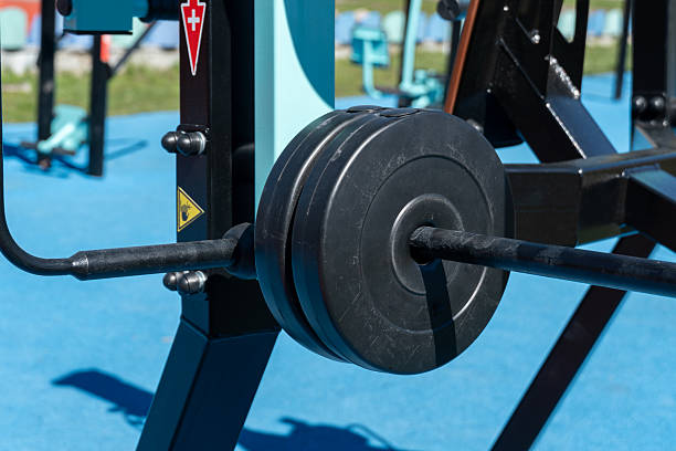 istock Advanced strength training apparatus featuring weights attached, situated in a lively outdoor gym environment surrounded by colorful landscapes 2224000362