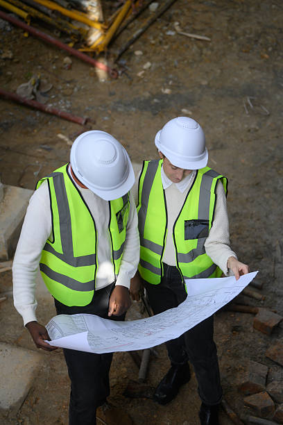 istock Engineers Reviewing Construction Plans on a Building Site 2224001772