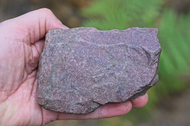 istock a man hand holds a big brown piece of stone 2224006901