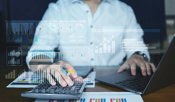 istock Close-up of hands working on a laptop with colorful virtual data dashboards overlay, showing charts, analytics, and KPI performance metrics. Modern workplace and technology concept. 2224007070