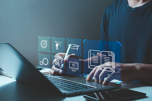 istock E-learning and online education concept with man using laptop and digital icons for virtual study and training.  Online course, virtual classroom, distance learning, and modern educational technology. 2224007110