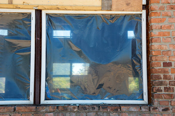 istock Renovation work is in progress as windows are covered with plastic sheeting in a brick building, letting in bright daylight 2224007132