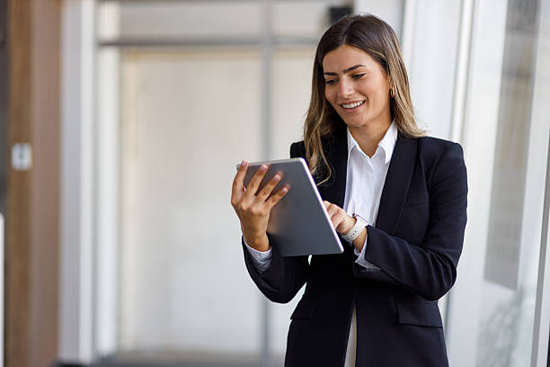 istock Professional businesswoman navigating digital tablet, embodying corporate success within contemporary workplace setting 2224007724