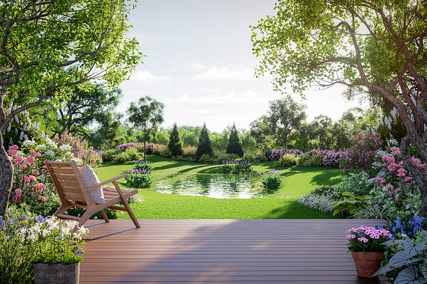 3D render of a tranquil garden with a wooden deck, floral armchair, lush plants, and a small pond, ideal for cozy outdoor lifestyle and nature-inspired scenes.