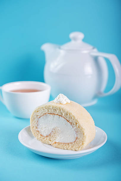 Vanilla cake roll with whipped cream filling in a plate