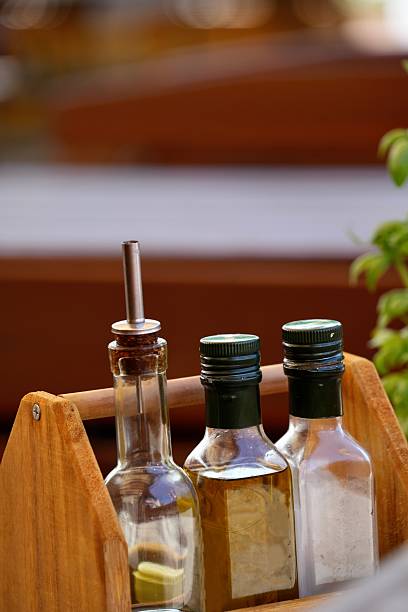 Liquid spices in glass bottles on the table in the restaurant.