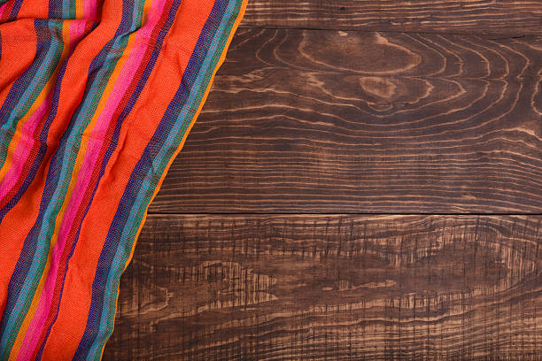 close up of rolled colorful clothes on the wooden table background