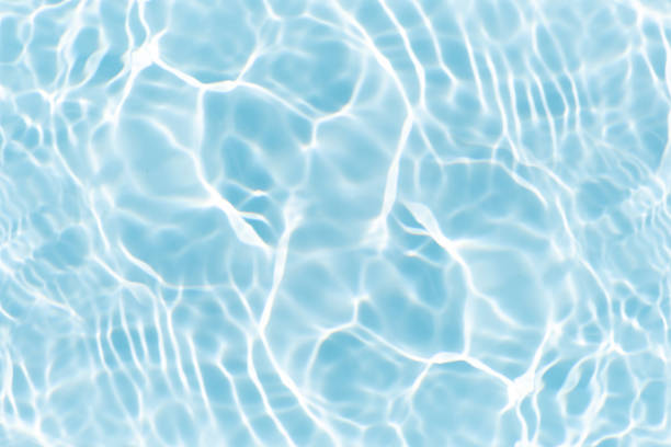 istock Blue water with ripples on the surface. Defocus blurred transparent blue colored clear calm water surface texture with splashes and bubbles. Water waves with shining pattern texture background. 2224015000