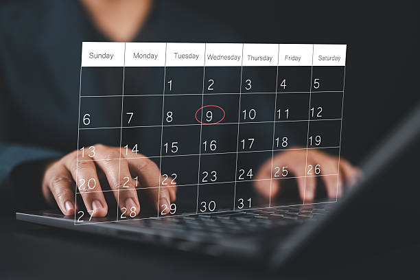 istock Time management concept. Calendar screen application with laptop. People manage time for effective work. Make an appointment, action plans, highlight reminders, and meeting agenda on the calendar. 2224015007