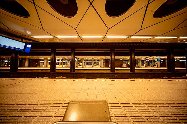 Amsterdam, Netherlands - July 6, 2025\n- The area where the trains leave the train station at Schiphol  Airport on a busy summer Sunday