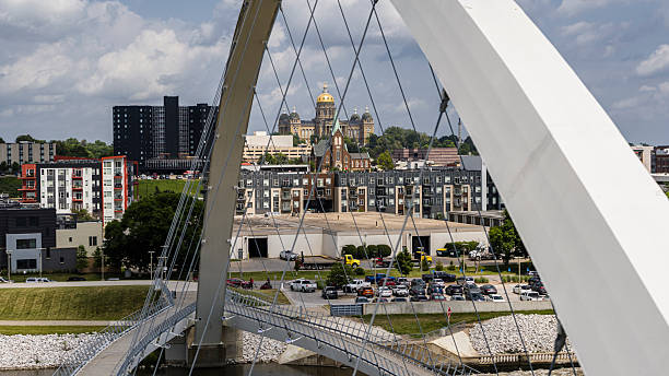 istock Urban sprawl transforms Des Moines waterfront in Iowa. Historic State Capitol and modern buildings blend under Women of Achievement Bridge arch 2224023091