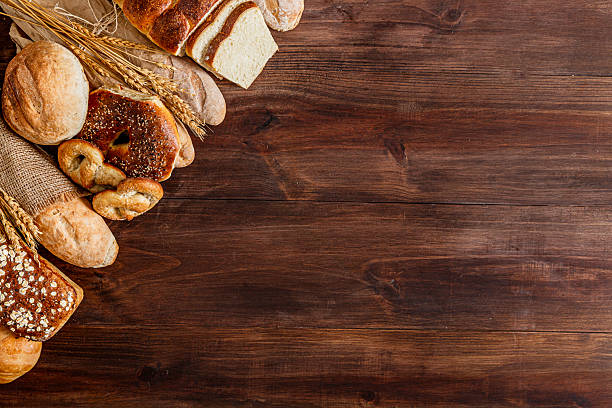 istock Assortment of bread making a frame on rustic wooden table with copy space 2224025409