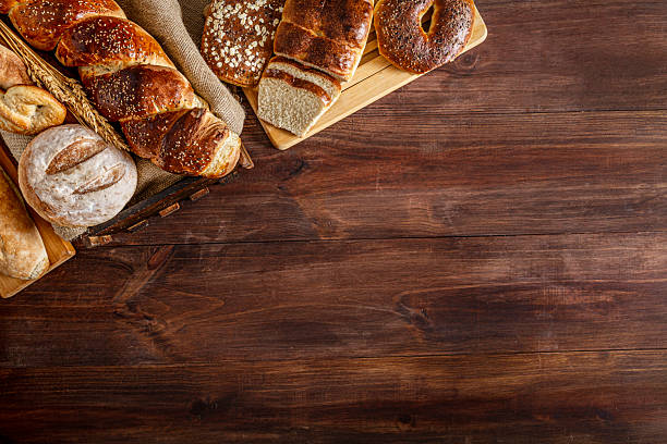 istock Assortment of bread making a frame on rustic wooden table with copy space 2224025455