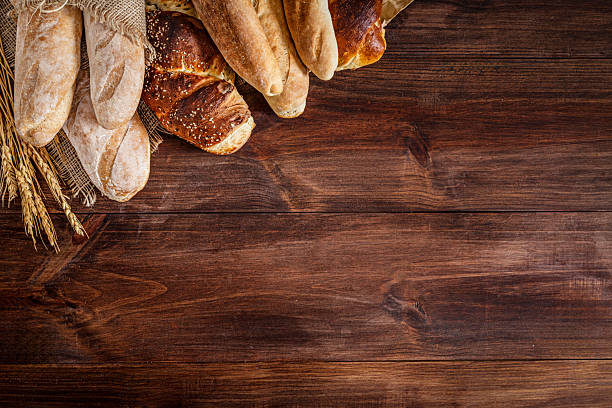 istock Assortment of bread making a frame on rustic wooden table with copy space 2224025471