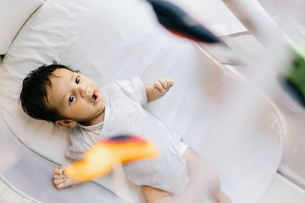 istock Newborn Baby Boy Looking At Hanging Play Mobile 2224033528