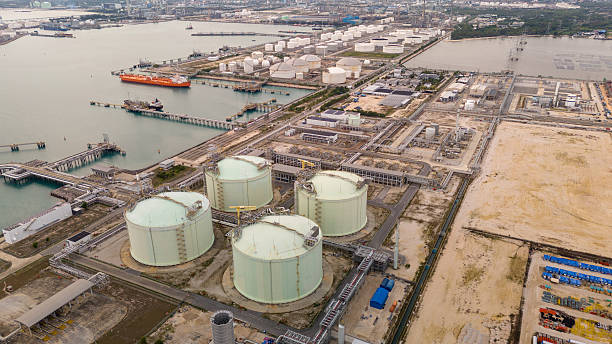 istock LNG storage tanks and terminal facility at dusk, showcasing large cylindrical containers, offshore piers, and cargo ships. Industrial landscape representing global liquefied natural gas 2224034552
