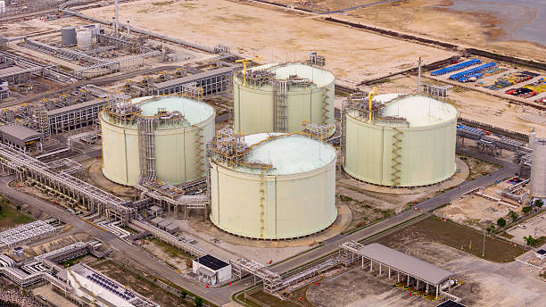istock LNG storage tanks and terminal facility at dusk, showcasing large cylindrical containers, offshore piers, and cargo ships. Industrial landscape representing global liquefied natural gas 2224034803