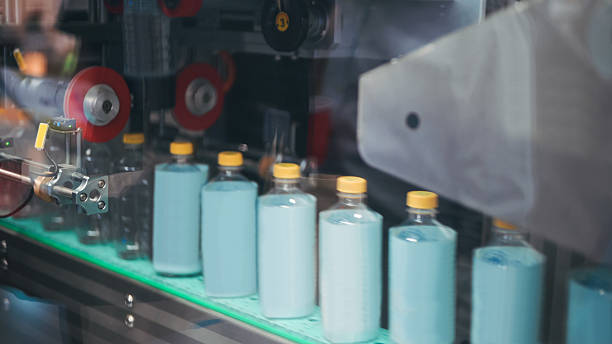 istock labeling and sealing packaging machine in PET plastic packaging drinking or beverage product packaging line automated labeling of round containers in smart production facility 2224035258