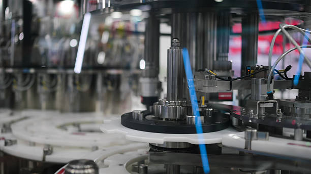 istock plastic bottle filling and capping automation in high-speed packaging line | precision dispensing and sealing machine in beverage or cosmetic production facility 2224035484